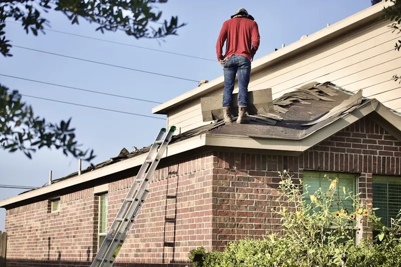 Professional roofer working on a residential roof in Sellman
